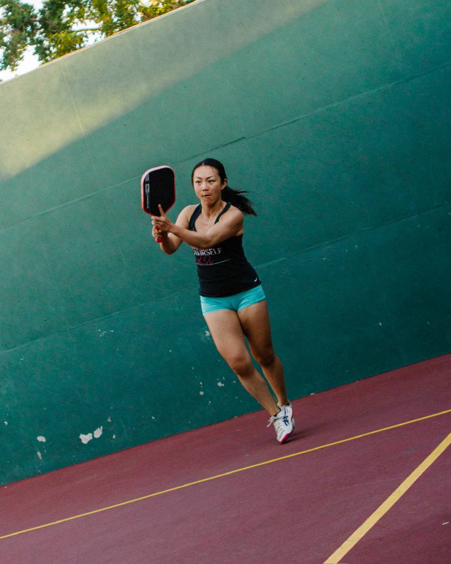Player holding a ready position with a paddle during an outdoor Los Angeles session